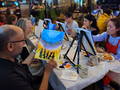 Attendees work on their paintings