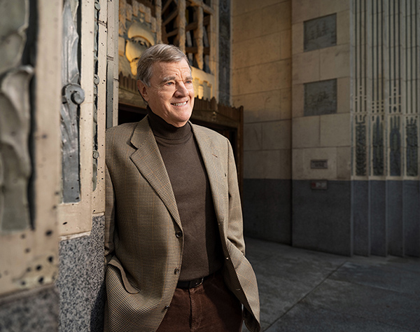 David Bowra stands in front of the Marine Building in Vancouver looking off camera