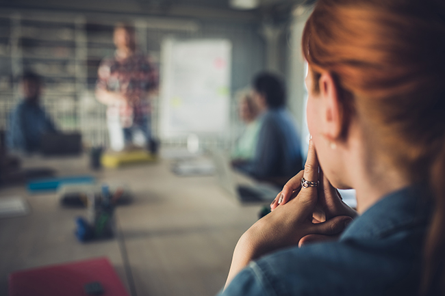 CPABC in Focus - Feature - woman thinking while people have a group discussion