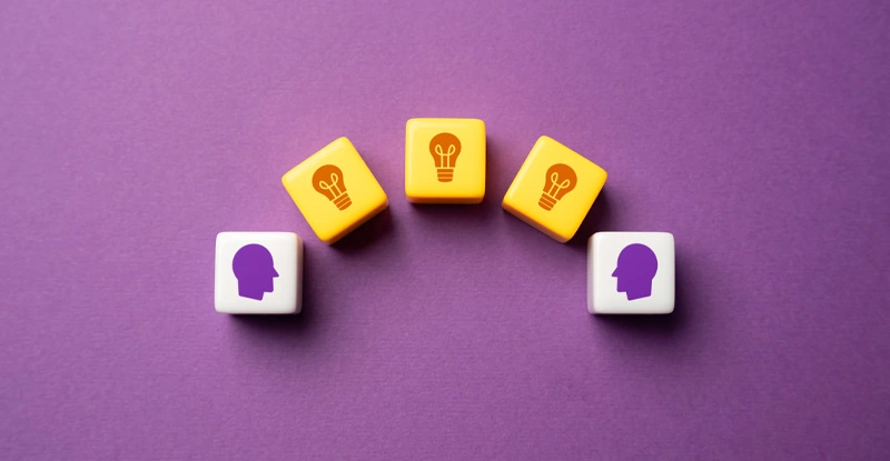 Cubes with "ideas" on them passing to and from cubes with images of "heads" on them
