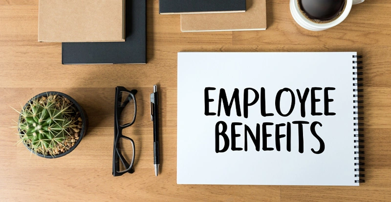 Pad of paper on a desk with EMPLOYEE BENEFITS written on it