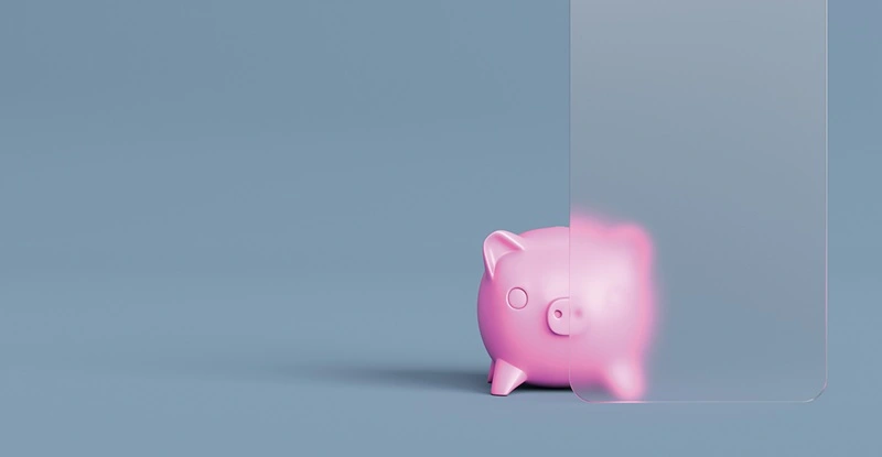 Pink piggy bank half hidden by frosted glass