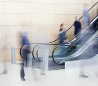 Business people on escalators