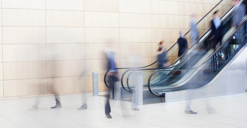 Business people on escalators
