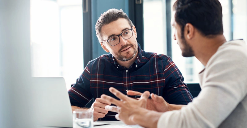 Two people working together at a table