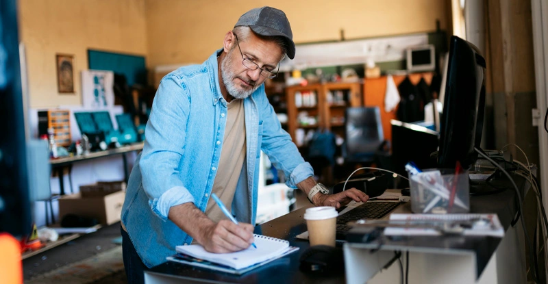 Man working at a computer in a workshop