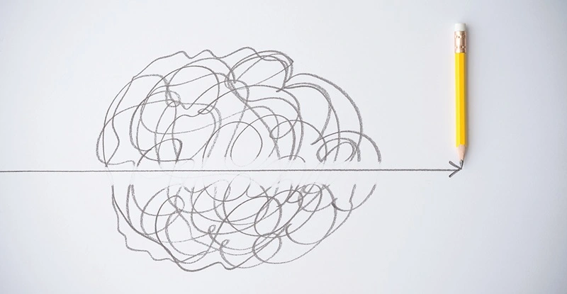 Penciled scribbles with an erased part in the middle with straight arrow drawn through it